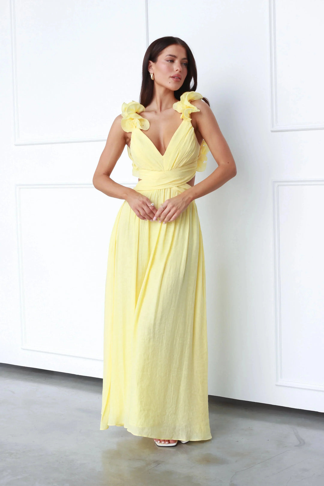 Yellow maxi dress with floral shoulder accents, made of lightweight cotton blend, perfect for a sunny day outing.