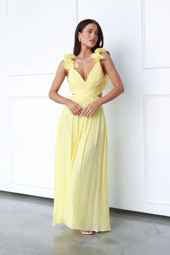 Yellow maxi dress with floral shoulder accents, made of lightweight cotton blend, perfect for a sunny day outing.