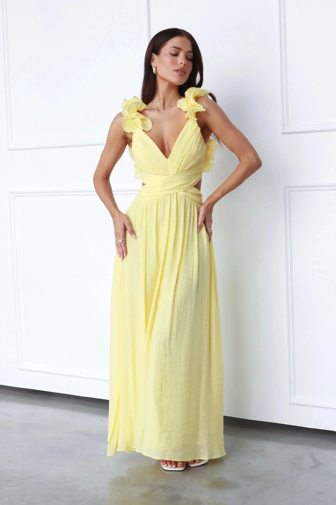 Yellow maxi dress with floral shoulder accents, made of lightweight material perfect for summer days.