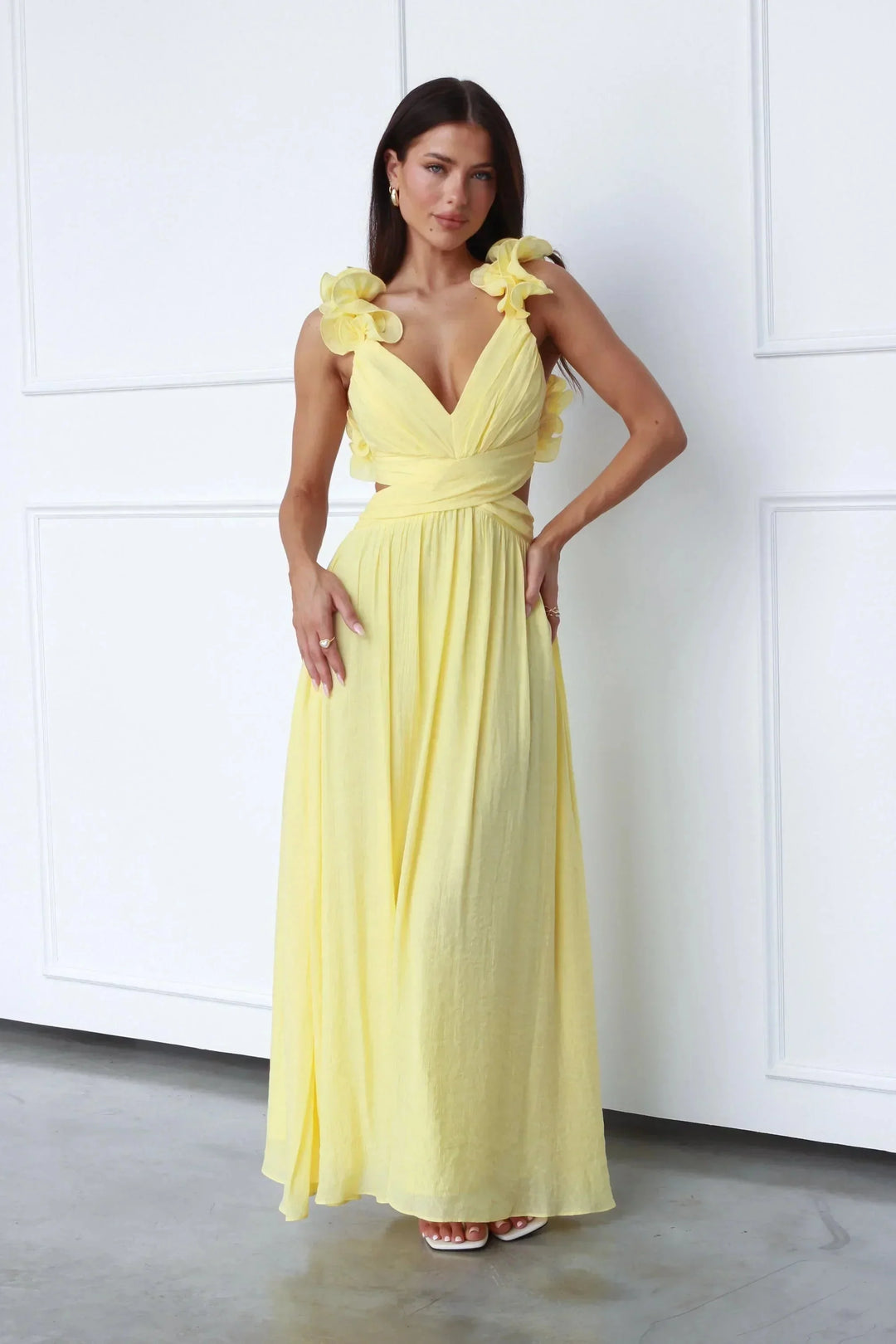 Yellow maxi dress with floral shoulder accents. Features a lightweight and breathable fabric suitable for casual outings or…