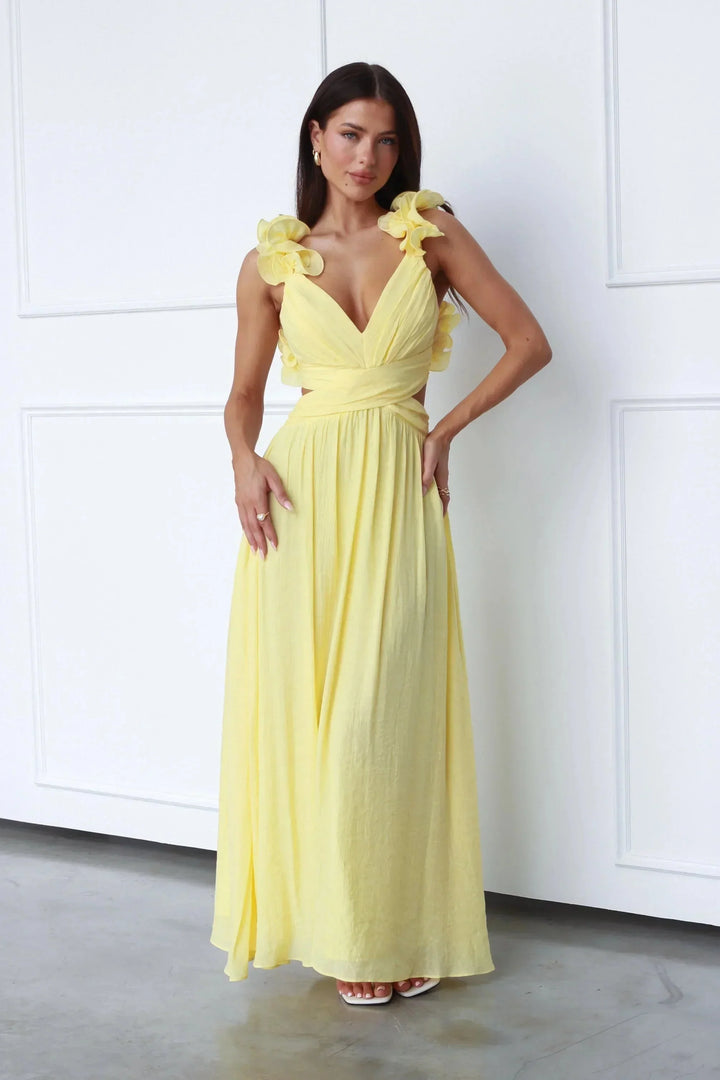 Yellow maxi dress with floral shoulder accents. Features a lightweight and breathable fabric suitable for casual outings or…