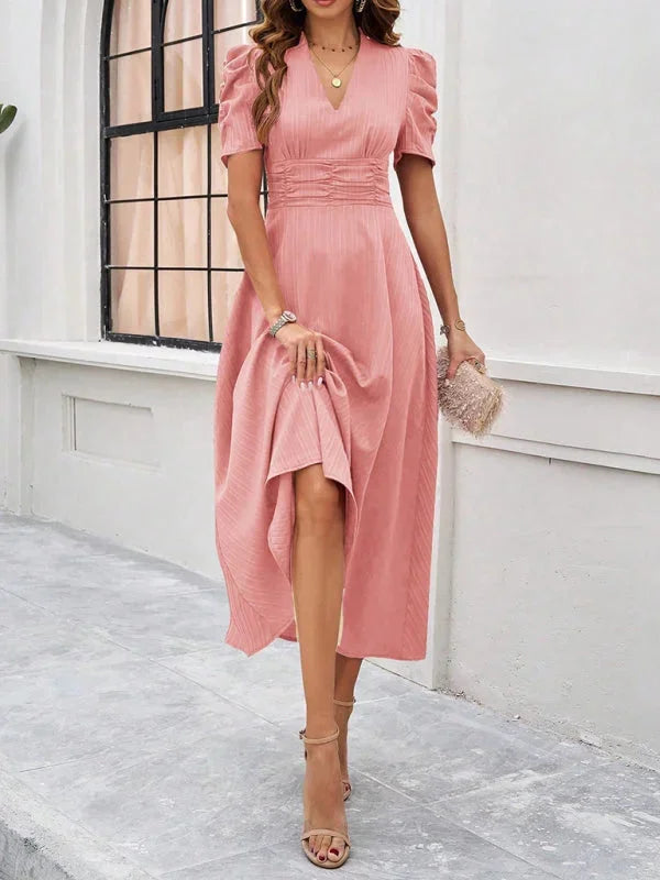Beige flowy midi dress with puff sleeves and a V-neck made of lightweight breathable fabric.