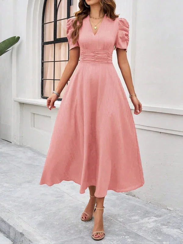 "Flowy pink puff sleeve V-neck midi dress in a soft fabric with a relaxed silhouette."