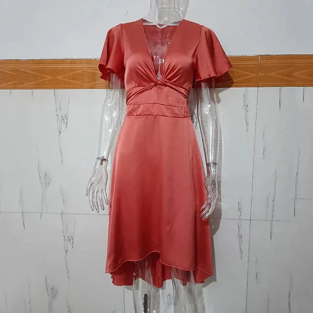 Asymmetric midi dress in Nahia featuring flutter sleeves and a modern design perfect for casual or formal occasions.