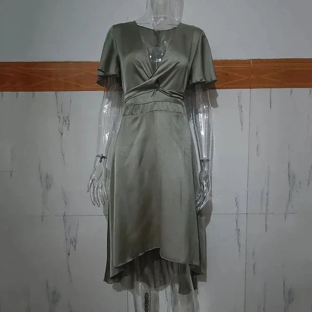 "Nahia midi dress in a striking asymmetrical design with flutter sleeves, perfect for effortless chic looks."