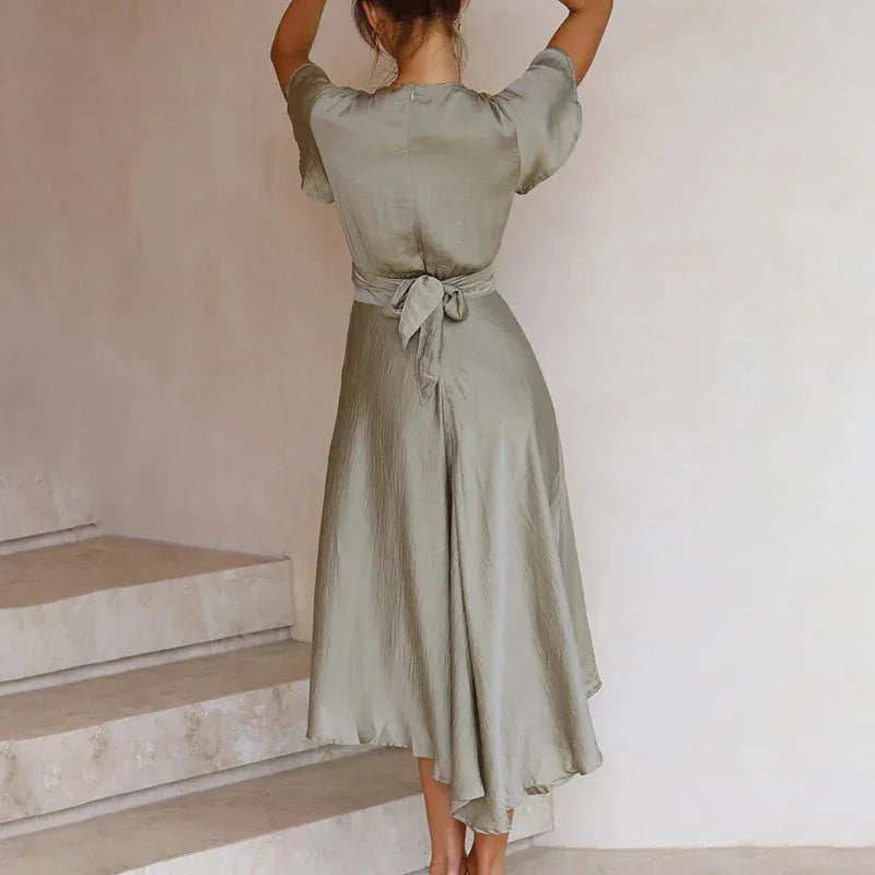 Nahia midi dress in black, asymmetric cut with flutter sleeves, perfect for casual or dressed-up occasions.