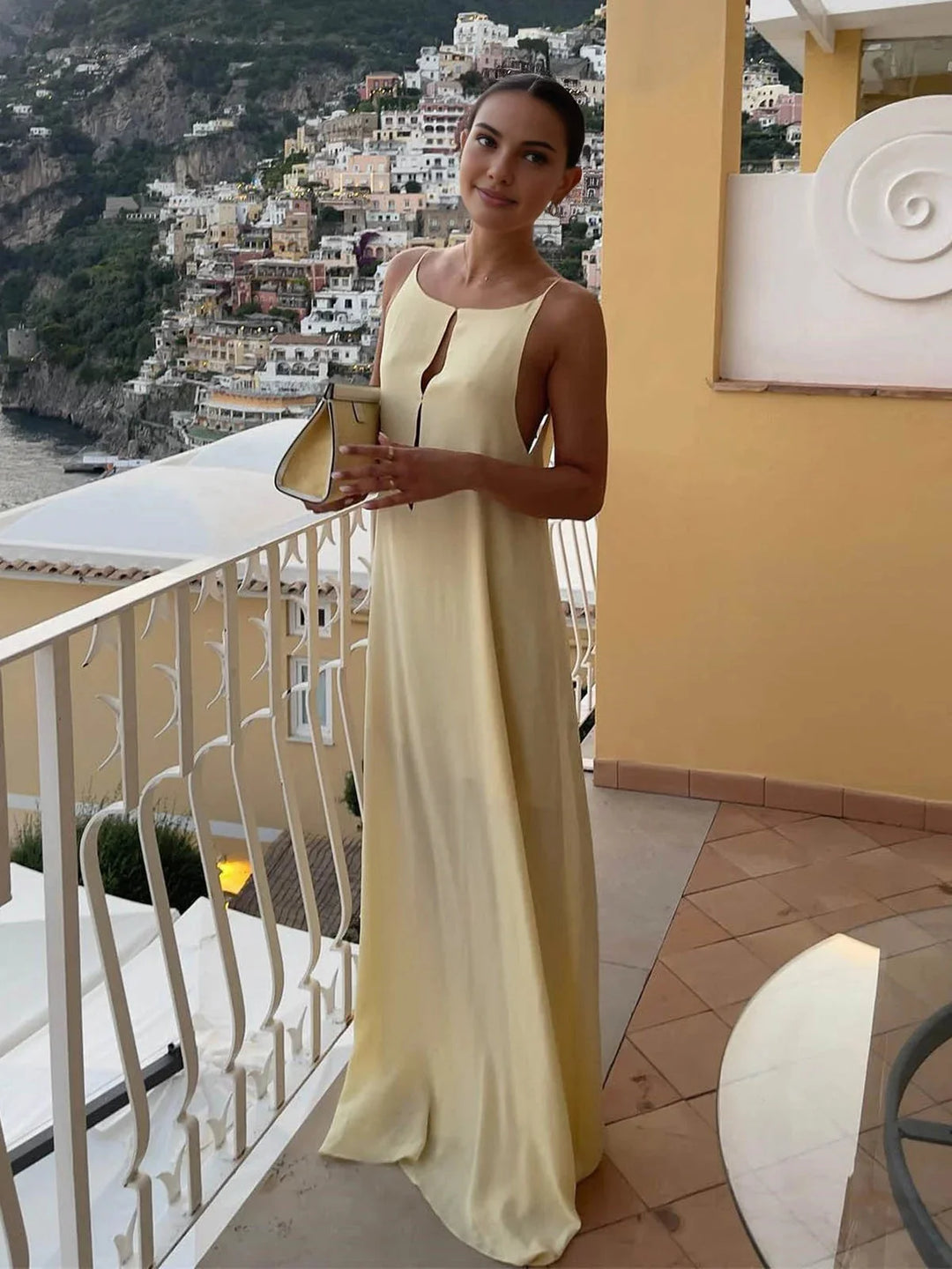 Women's black backless maxi dress with sleek straps, crafted from soft and breathable fabric, perfect for an elegant and…