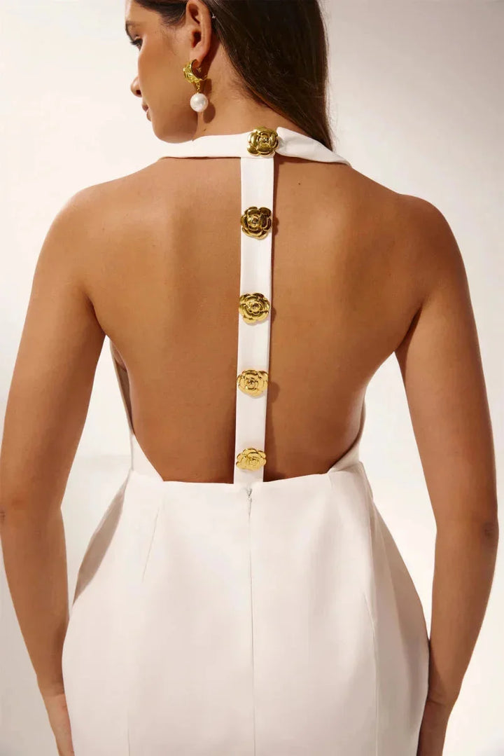 White halter mini dress adorned with delicate floral appliques, perfect for sunny days or special occasions.
