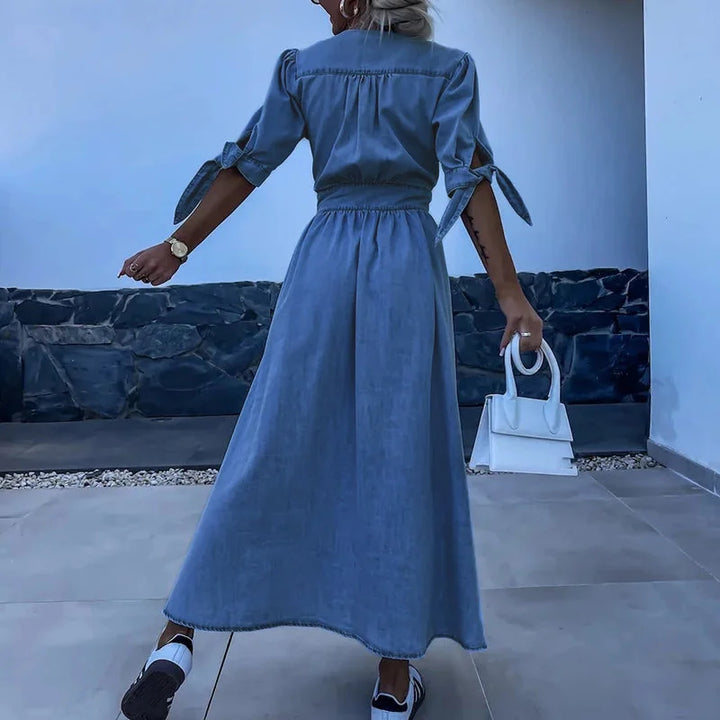 "Blue denim dress with button-front closure, tie sleeves, and a casual look."