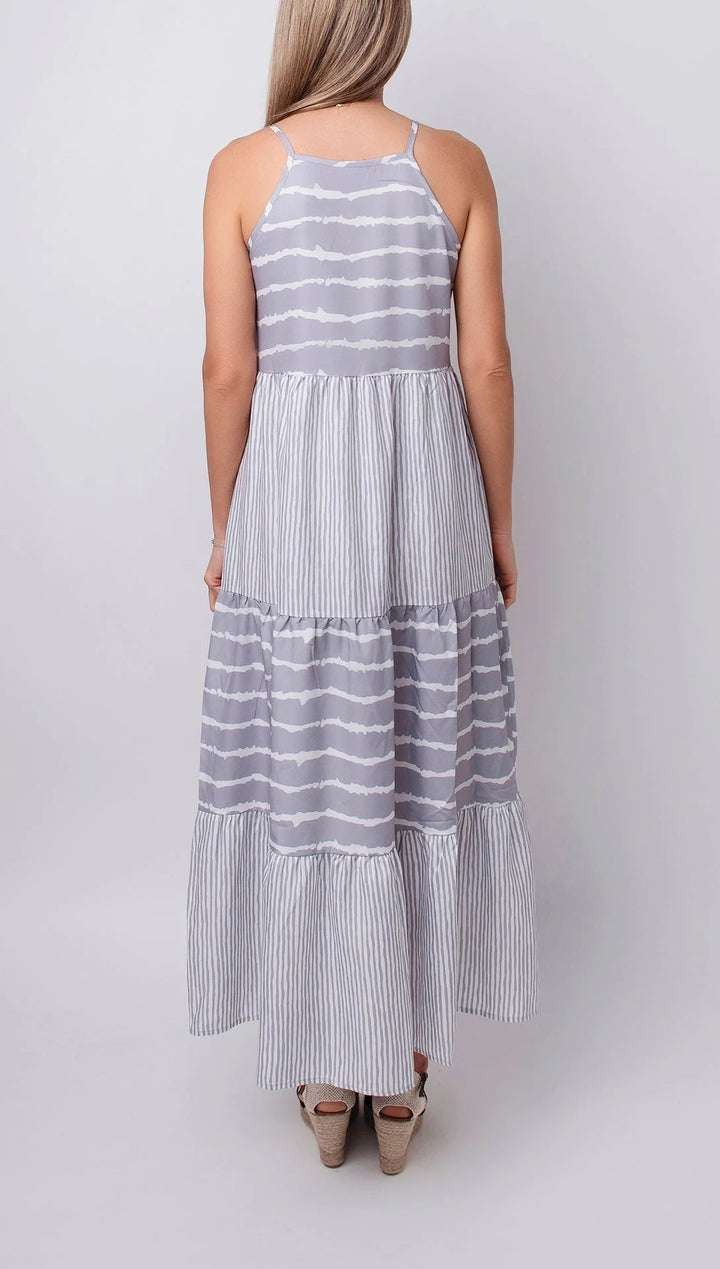 Sleeveless grey maxi dress with tiers, crafted from soft, flowy fabric. Features a tiered design for an effortless and chic…