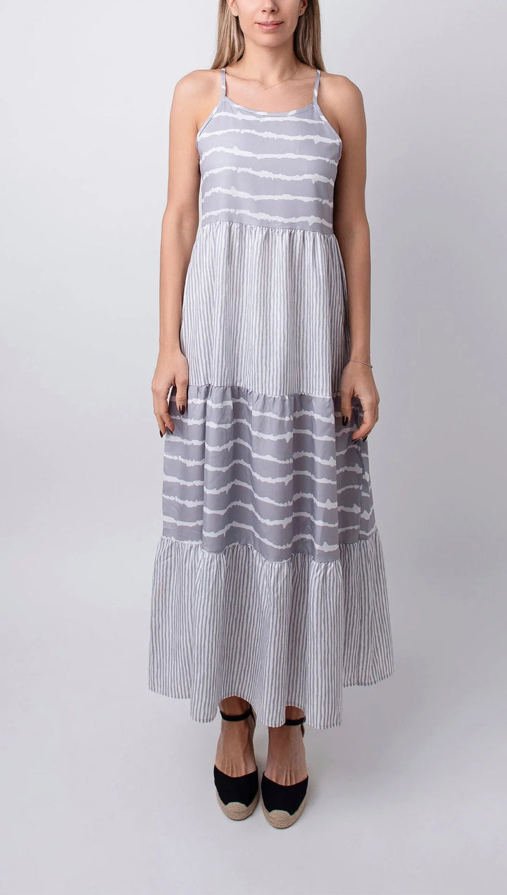 "Sleeveless grey maxi dress with tiers made of soft, flowing fabric in Fresno, featuring a relaxed silhouette and elegant…
