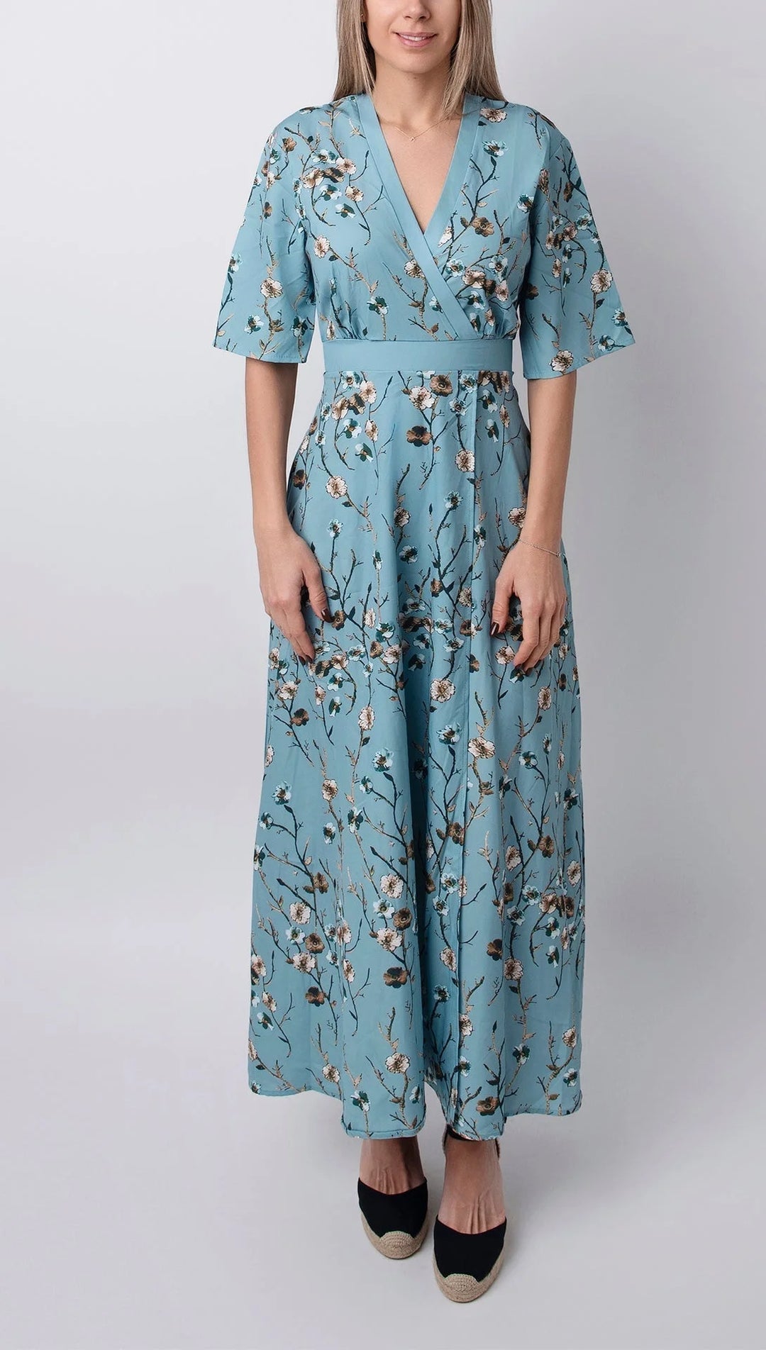 Light blue maxi dress with floral print and half sleeves in soft and flowy fabric, perfect for a casual and chic look.
