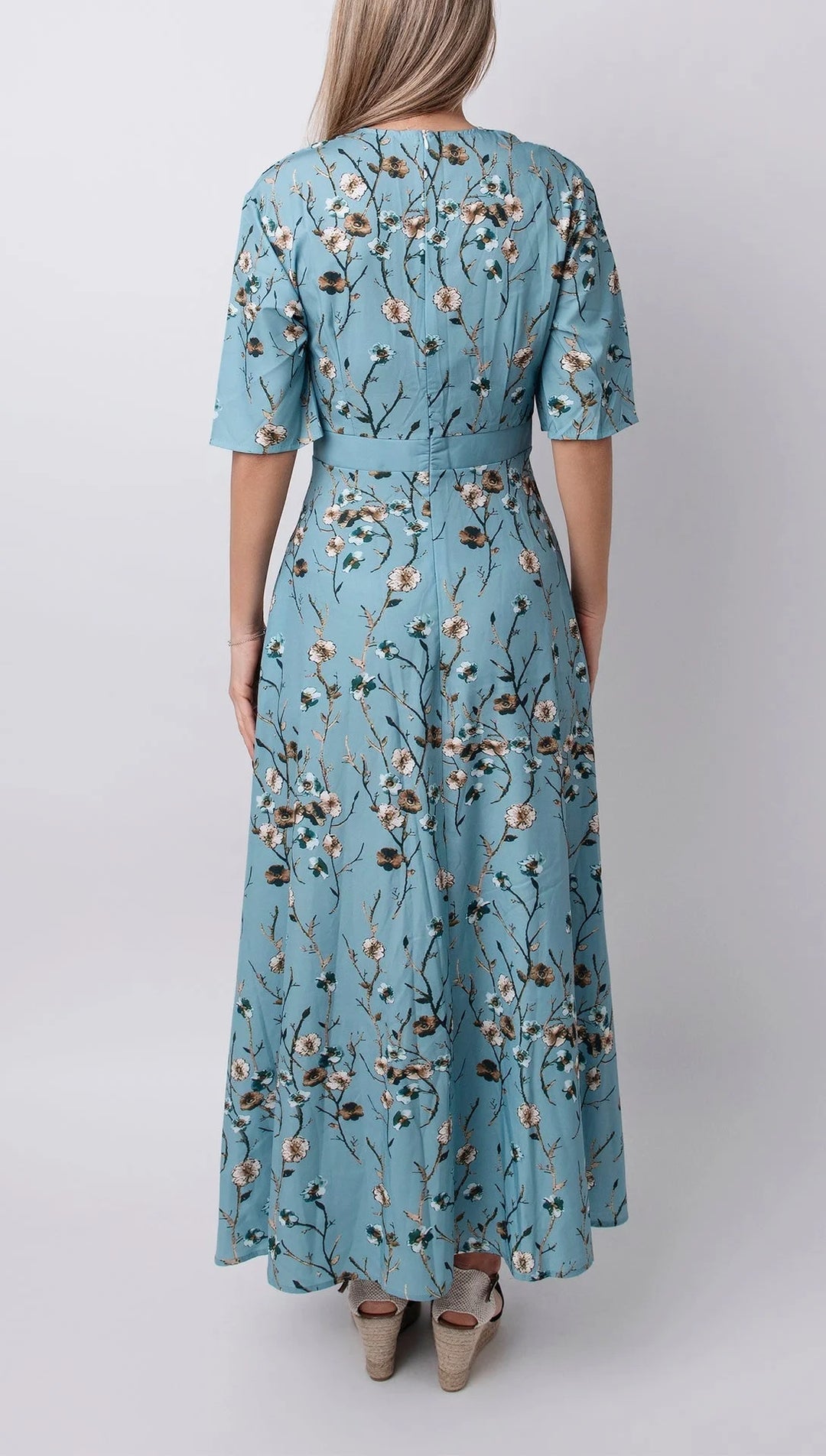 Light blue maxi dress with floral print, half sleeves, and a relaxed fit. Perfect for a casual and chic look.