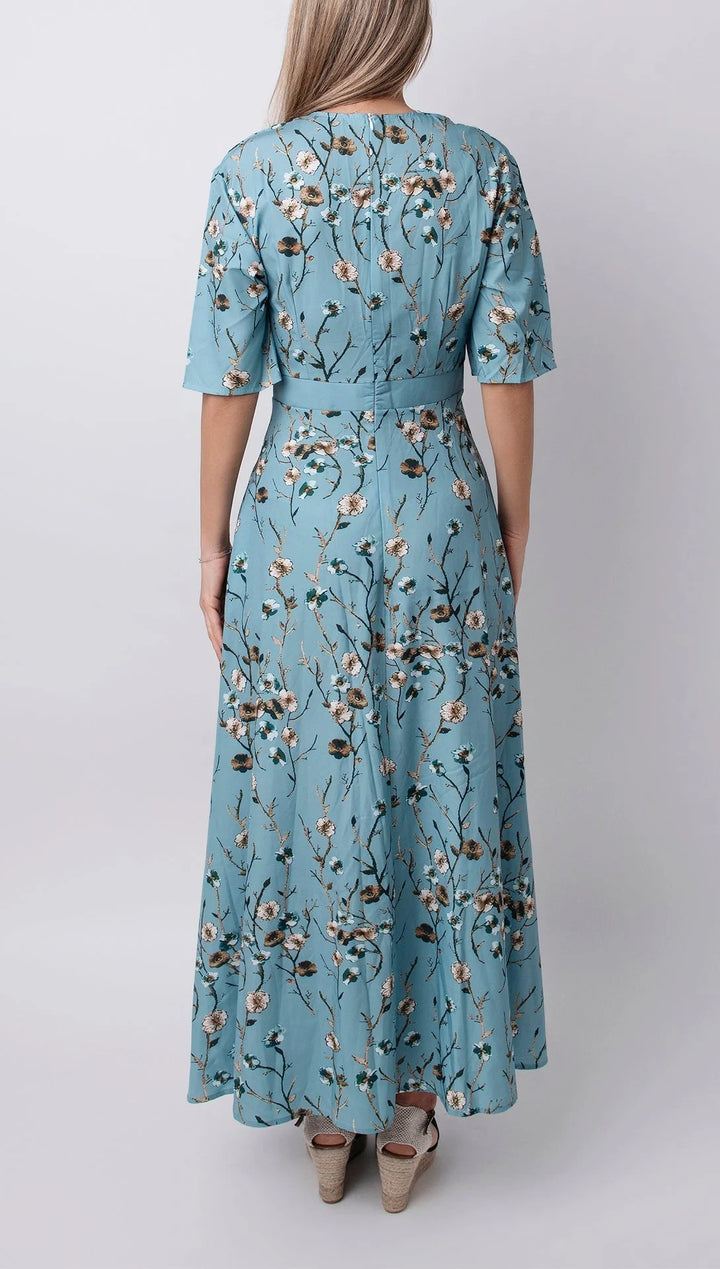 Light blue maxi dress with floral print, half sleeves, and a relaxed fit. Perfect for a casual and chic look.