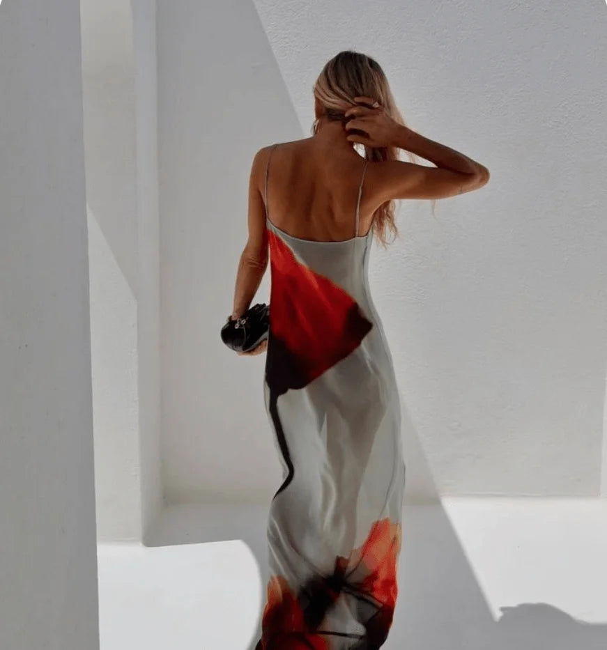 Flowy abstract maxi dress in red and grey, featuring an intricate design of swirling patterns with a relaxed fit and made…