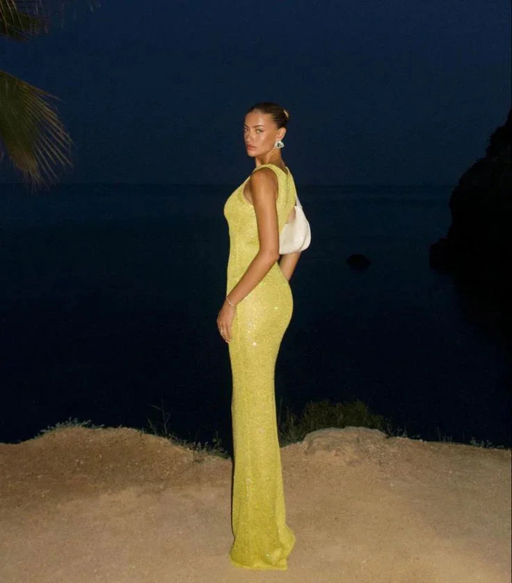 Sleeveless evening dress featuring sparkling sequins on a sleek design by Oaklynn.