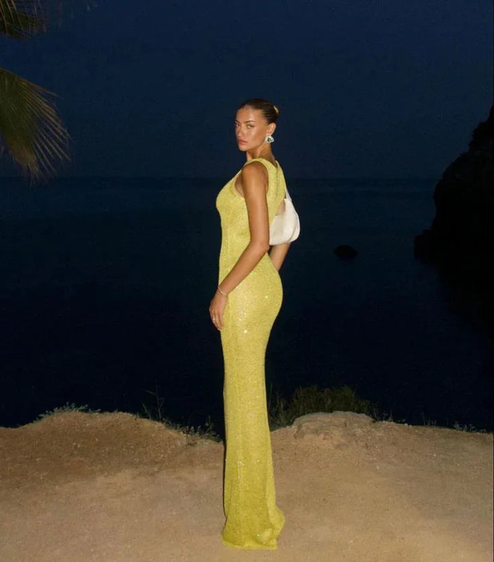 Sleeveless evening dress featuring sparkling sequins on a sleek design by Oaklynn.