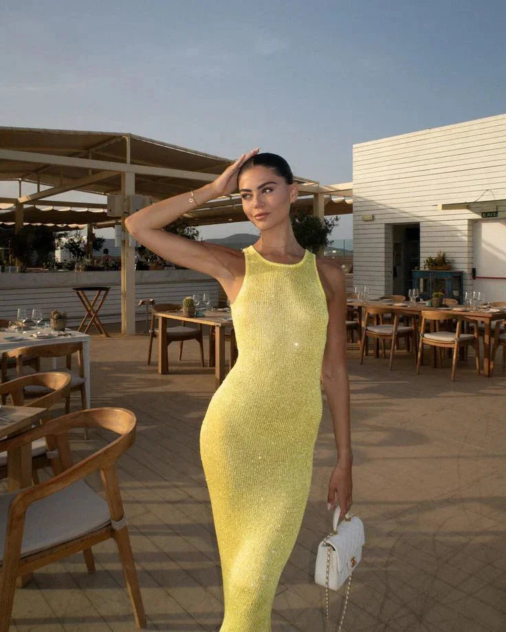 Yellow sleeveless evening wear with sparkling fabric, perfect for special occasions.