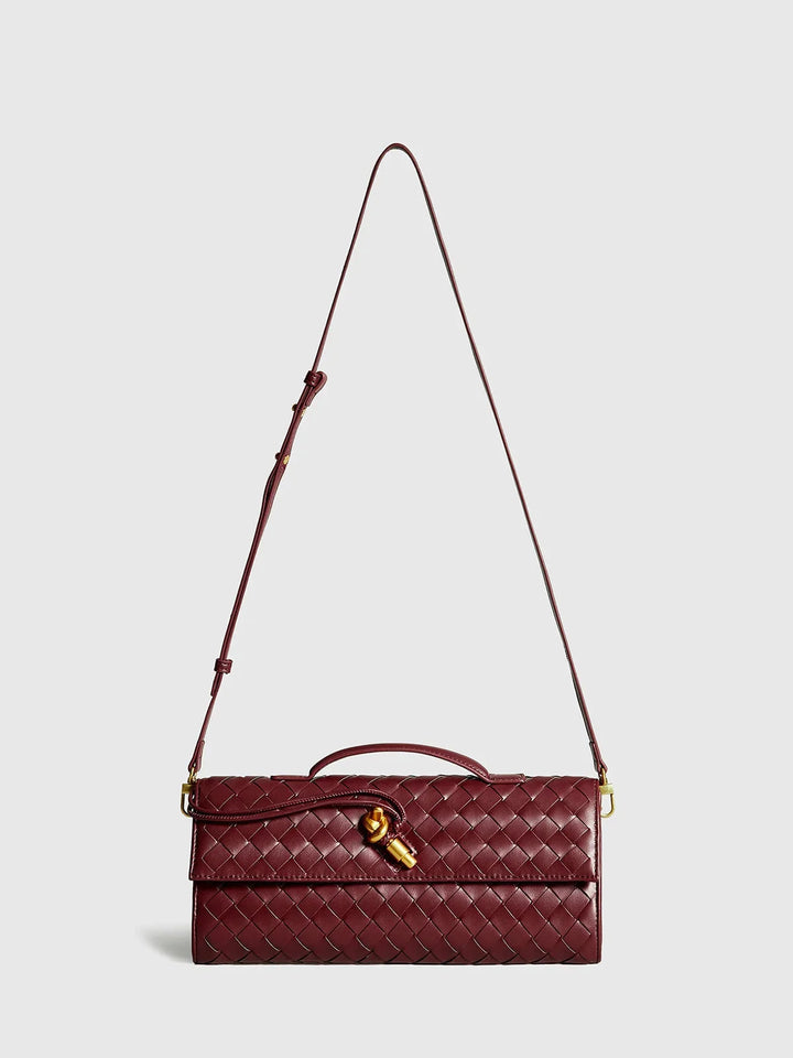 Opal shoulder bag with quilted detailing, secure clasp, and adjustable strap in taupe color.