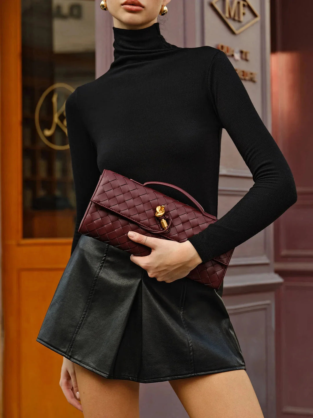 Maroon quilted shoulder bag with secure clasp, showcasing opulent opal detailing.