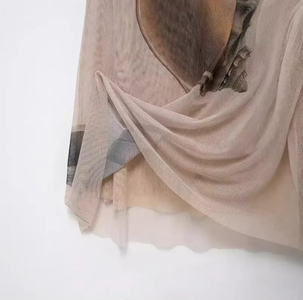 "Beige maxi dress featuring delicate shell print design, perfect for a chic and sophisticated look."