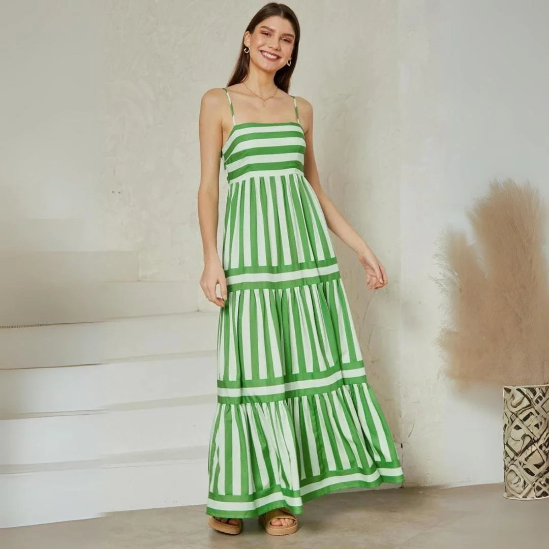 Green tiered striped maxi dress with spaghetti straps, perfect for summer. Made of lightweight, breathable fabric for a…
