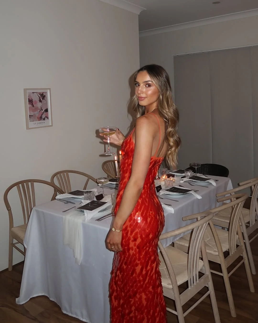 Red sequin maxi dress with deep neckline, perfect for a glamorous night out. Sparkling sequins catch the light beautifully.