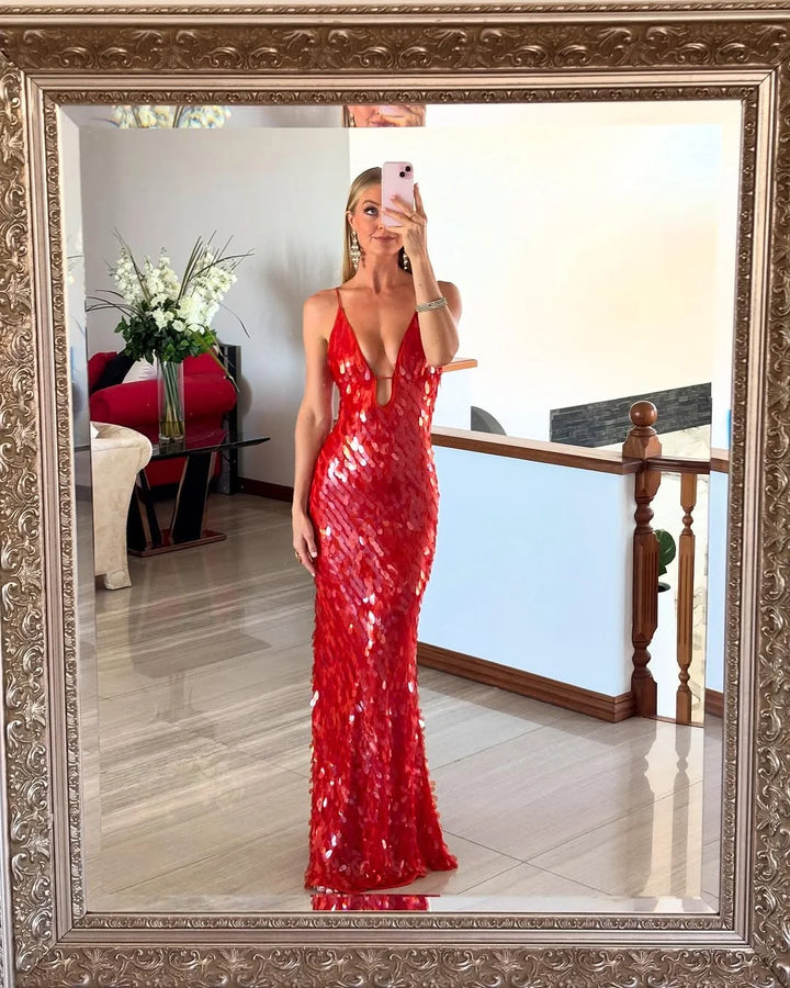 Red sequin maxi dress with deep neckline, perfect for a glamorous evening. Sparkling sequin embellishments on flowy fabric.