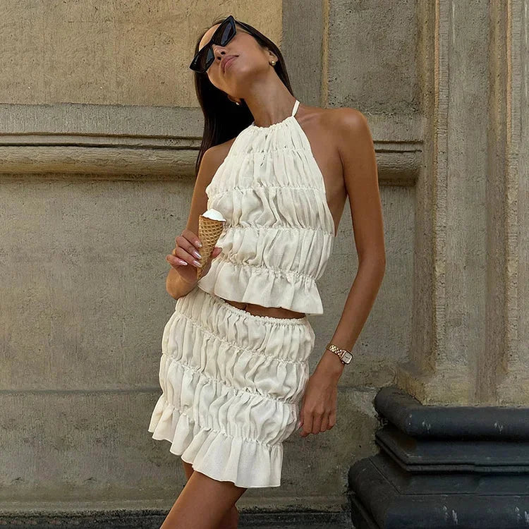 Apricot two-piece set with halter neckline. Features a pleated design for a chic and stylish look.