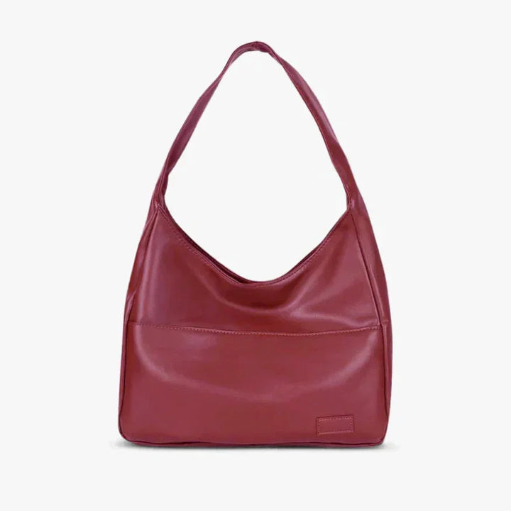 Wine red shoulder bag with modern design and sleek finish perfect for everyday use.