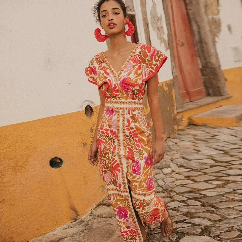 "Red floral maxi dress for women with slit detail, perfect for summer events, made of lightweight, breathable fabric."