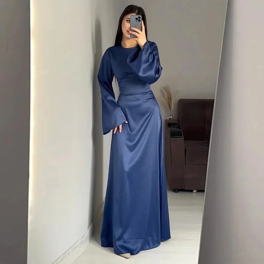 Blue floor-length dress with bell sleeves, soft chiffon fabric. Feminine and graceful silhouette, perfect for special…