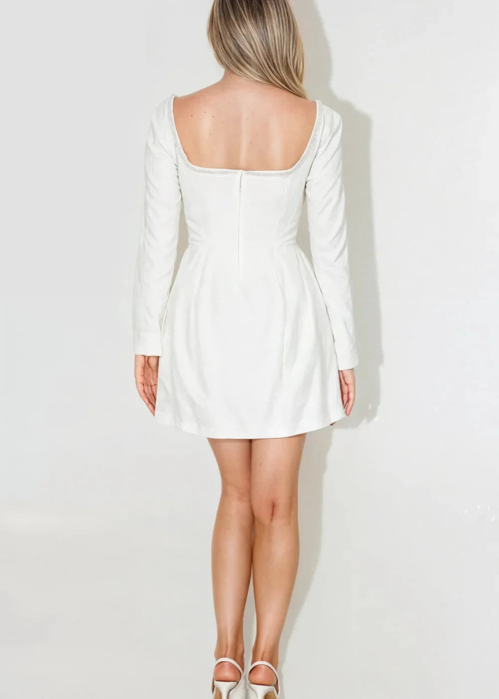 "Black square neck mini dress with bead detailing, perfect for a chic evening look."