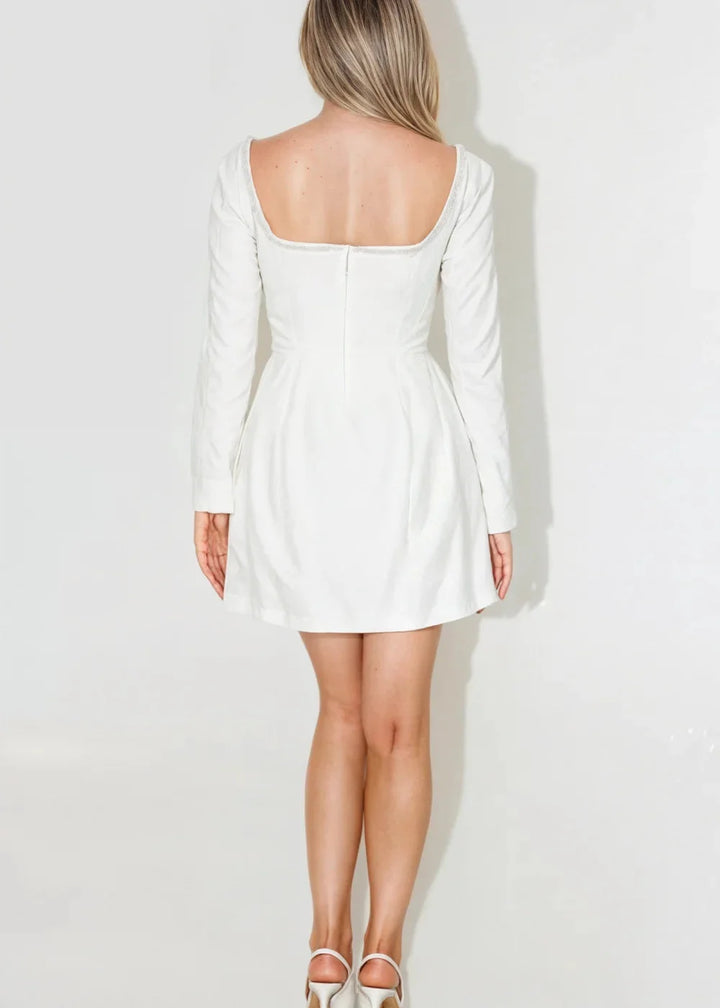 "Black square neck mini dress with bead detailing, perfect for a chic evening look."