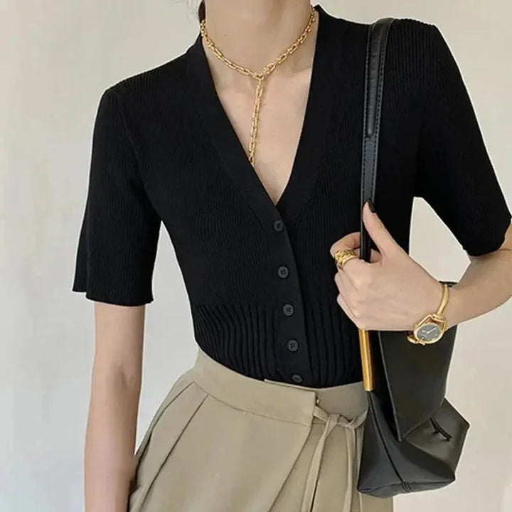 "Rhoda fitted knit cardigan in gray with front buttons, ribbed detailing, and v-neck collar."