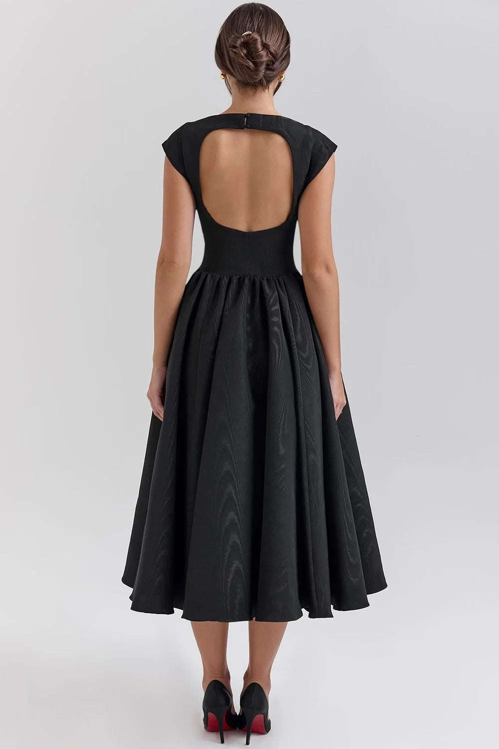 "Black mid-length dress with sculpted bodice and elegant design, perfect for special occasions."