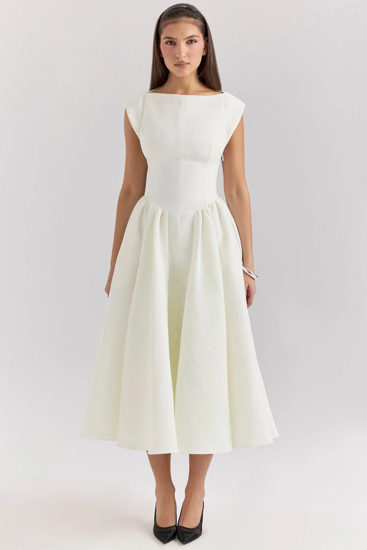 White mid-length dress with a sculpted bodice, perfect for events. Textured fabric accents, 3/4 sleeves, and gentle pleating…