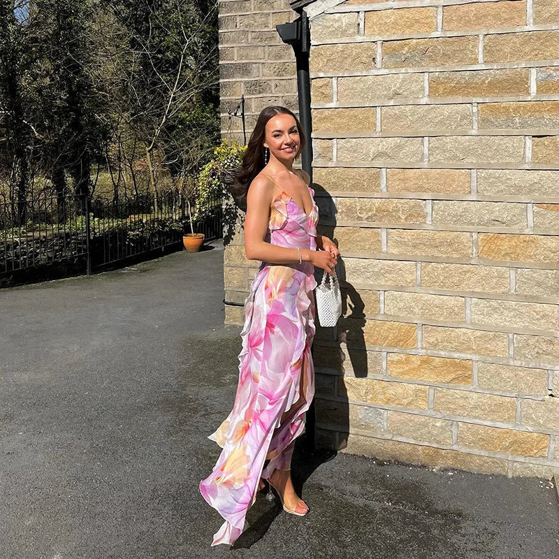 "Sleeveless maxi dress with ruffle trim, featuring a vibrant floral print. Perfect for a summer day out or beach vacation."