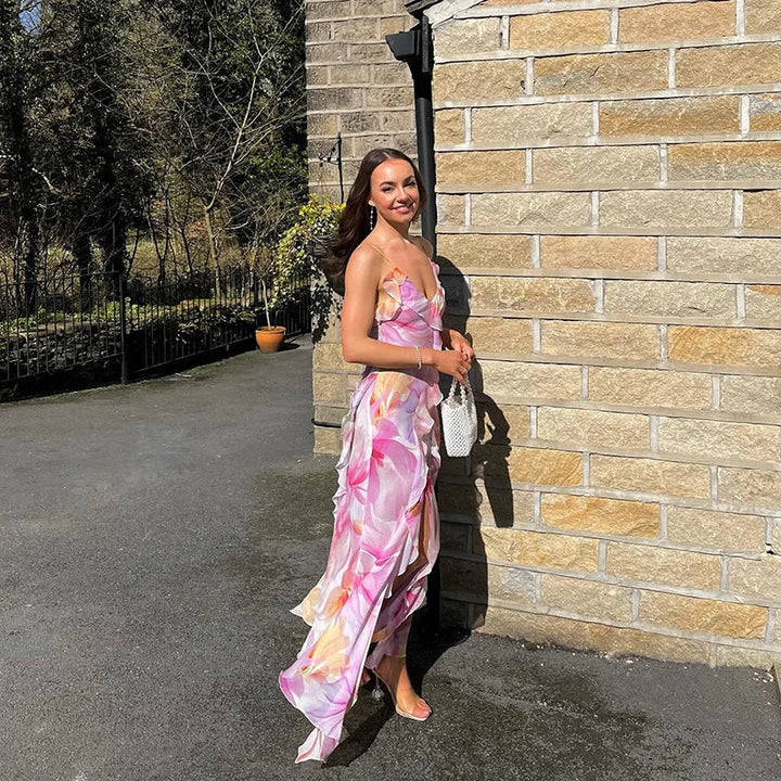 "Sleeveless maxi dress with ruffle trim, featuring a vibrant floral print. Perfect for a summer day out or beach vacation."
