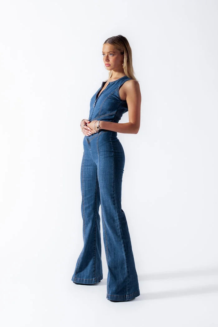 "Sleeveless blue denim jumpsuit with zipper closure, perfect for a casual yet chic look."