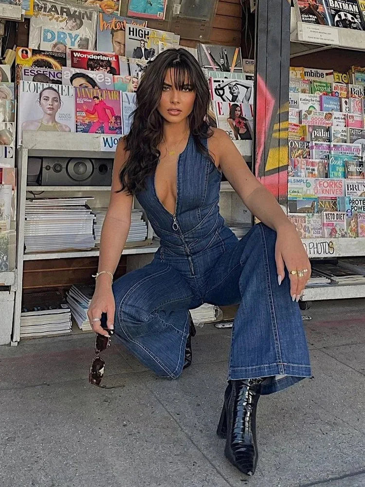 Sleeveless blue denim jumpsuit with zipper, featuring a flattering fit and functional design for a versatile and trendy look.