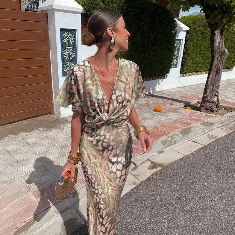 Green V-neck wrap dress with stylish prints, knee-length, made of soft and sustainable fabric, perfect for casual or special…