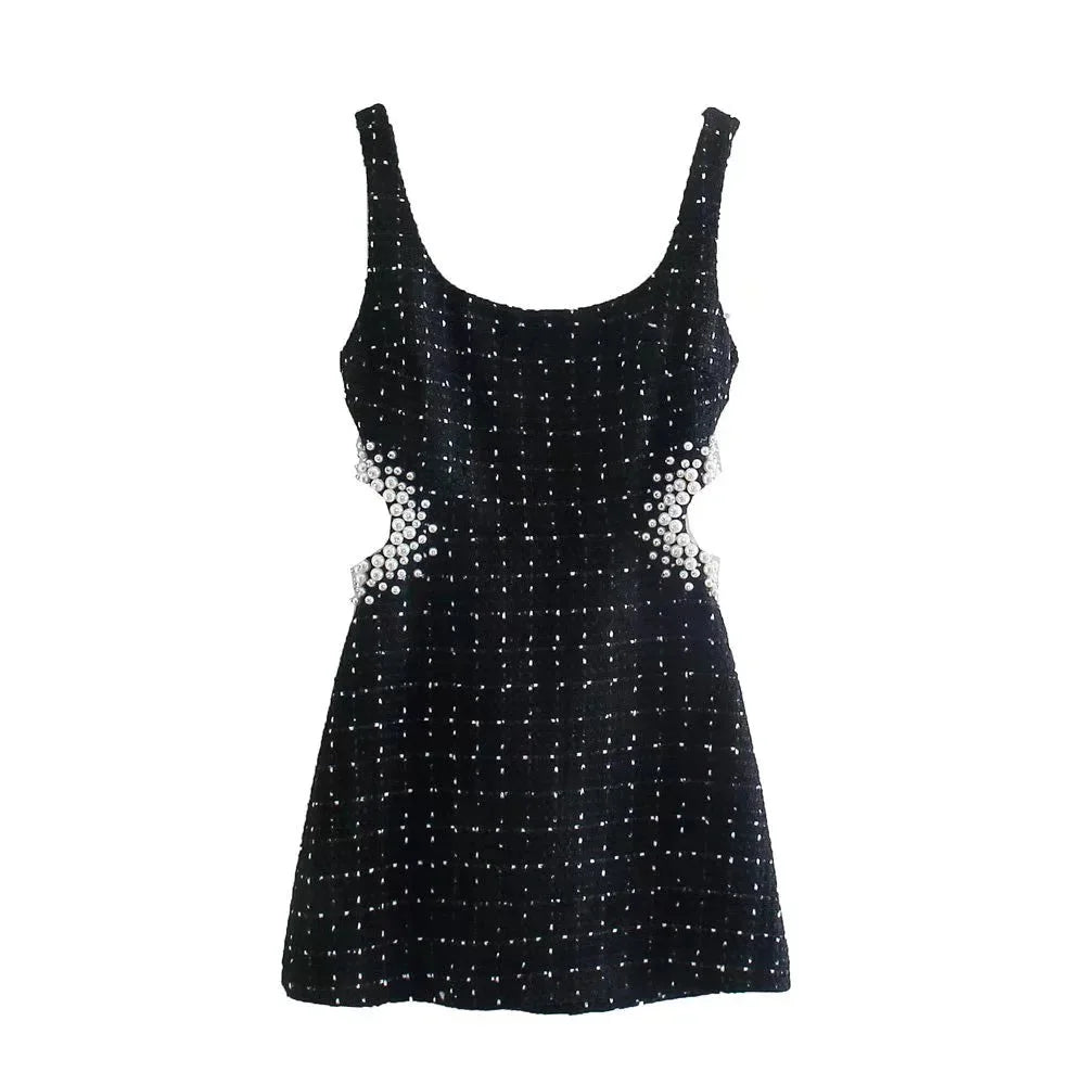Black dress with pearl accents, featuring beaded detailing throughout.