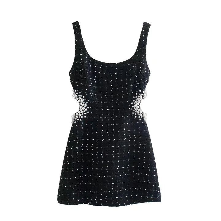 Black dress with pearl accents, featuring beaded detailing throughout.