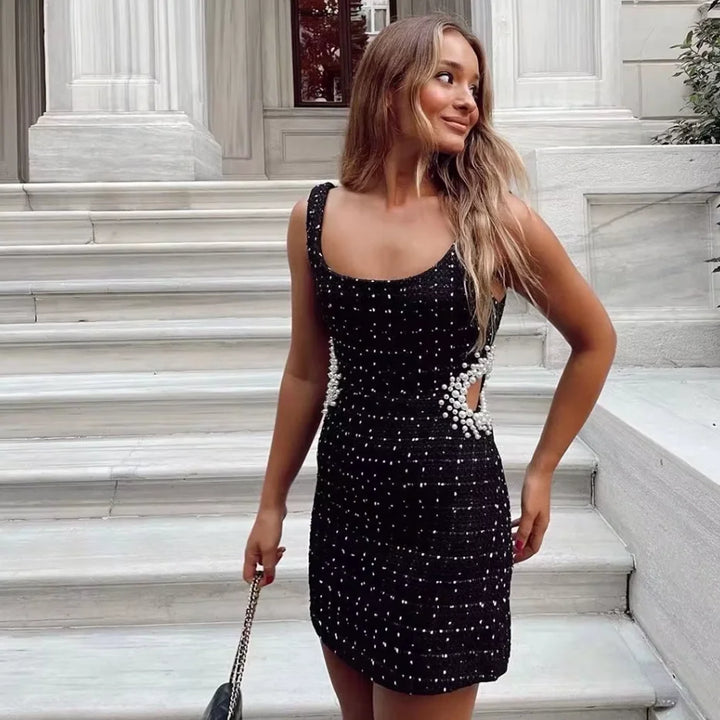 Black beaded dress with pearl accents for a sophisticated look.