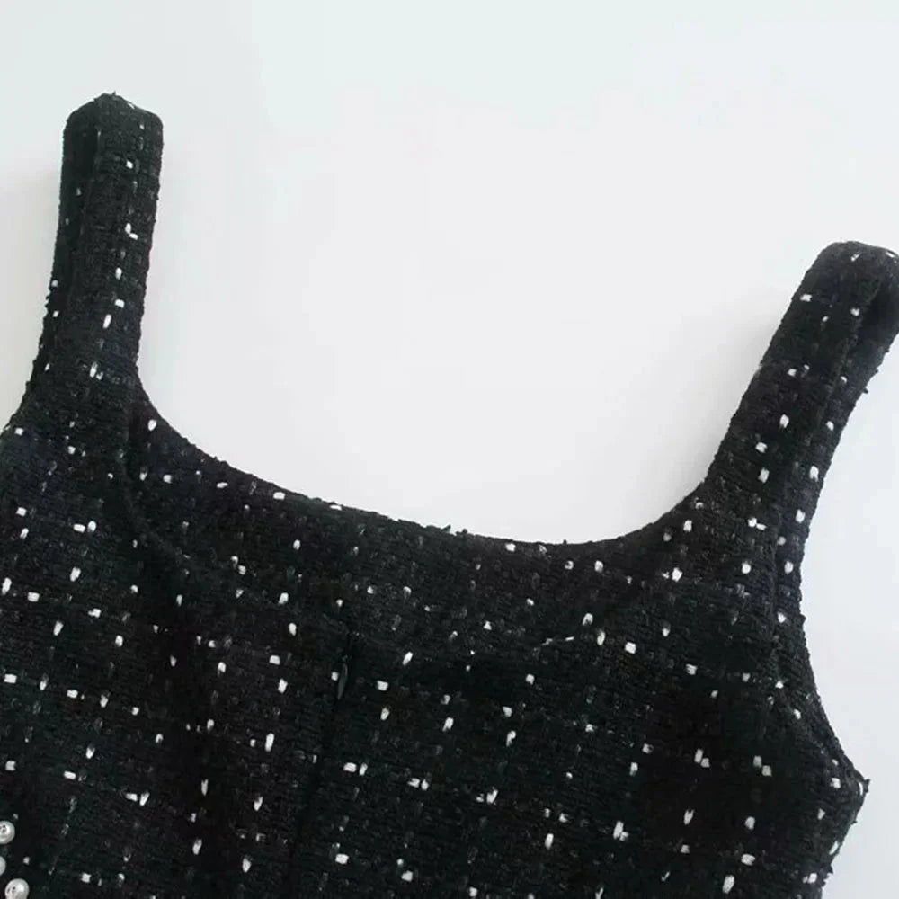 Black knee-length dress with intricate beadwork and pearl accents. Made from high-quality materials for a stylish evening…