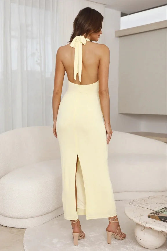 Yellow pleated halter maxi dress with a flowy silhouette. Perfect for a casual chic look.