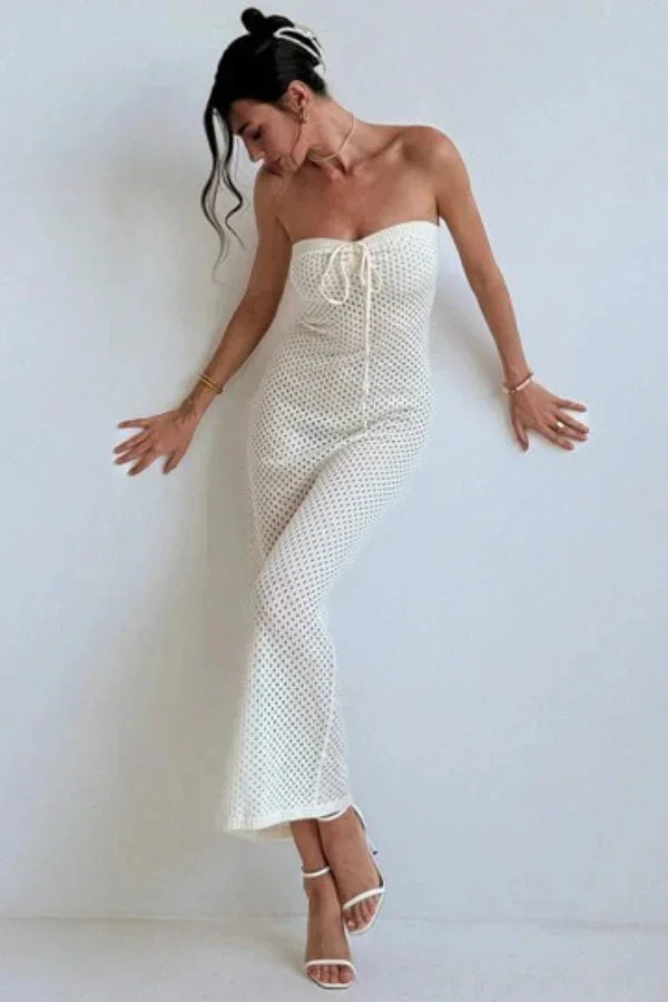 Cream crochet maxi dress with a strapless design, perfect for warm weather. Features intricate crochet detailing and a flowy…