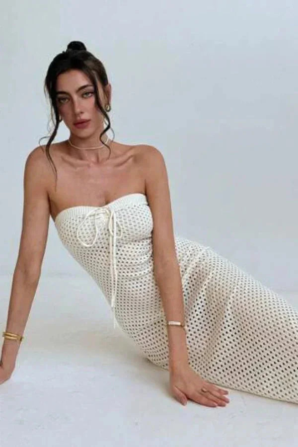 Strapless cream crochet maxi dress featuring intricate crochet design and flowing silhouette.
