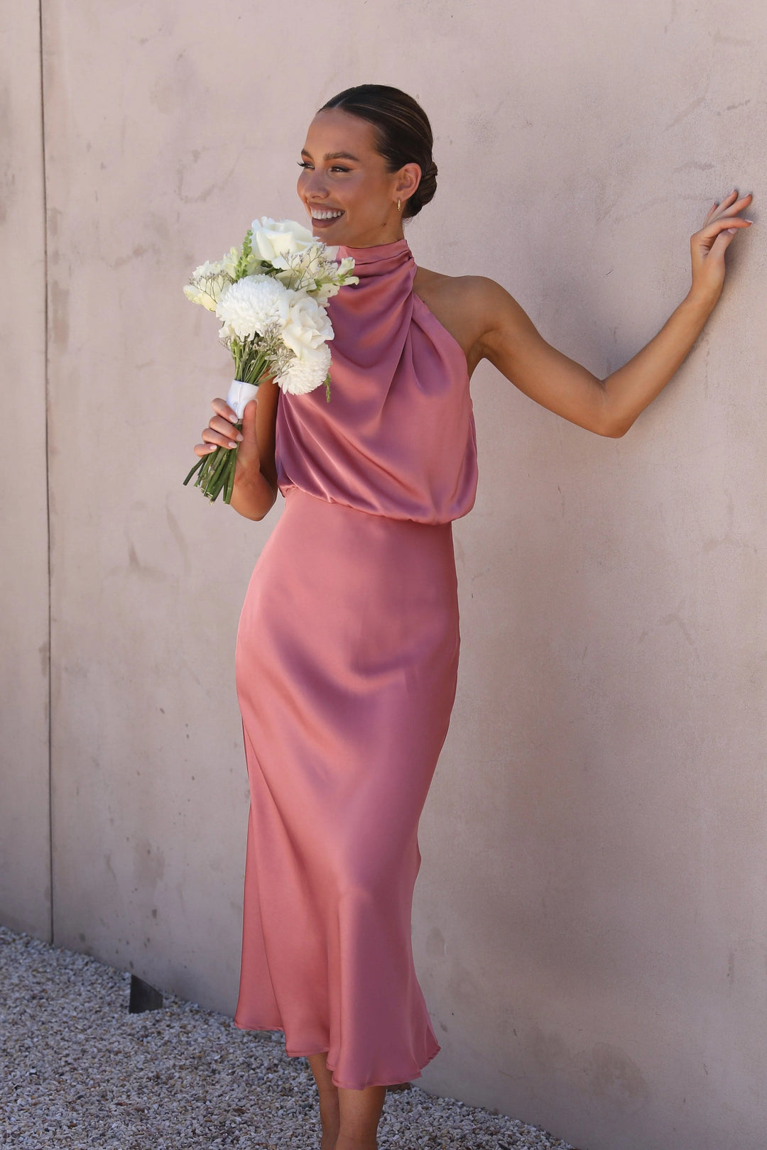 Pink satin skirt and top set with flowing design. Perfect ensemble for a chic and elegant look.